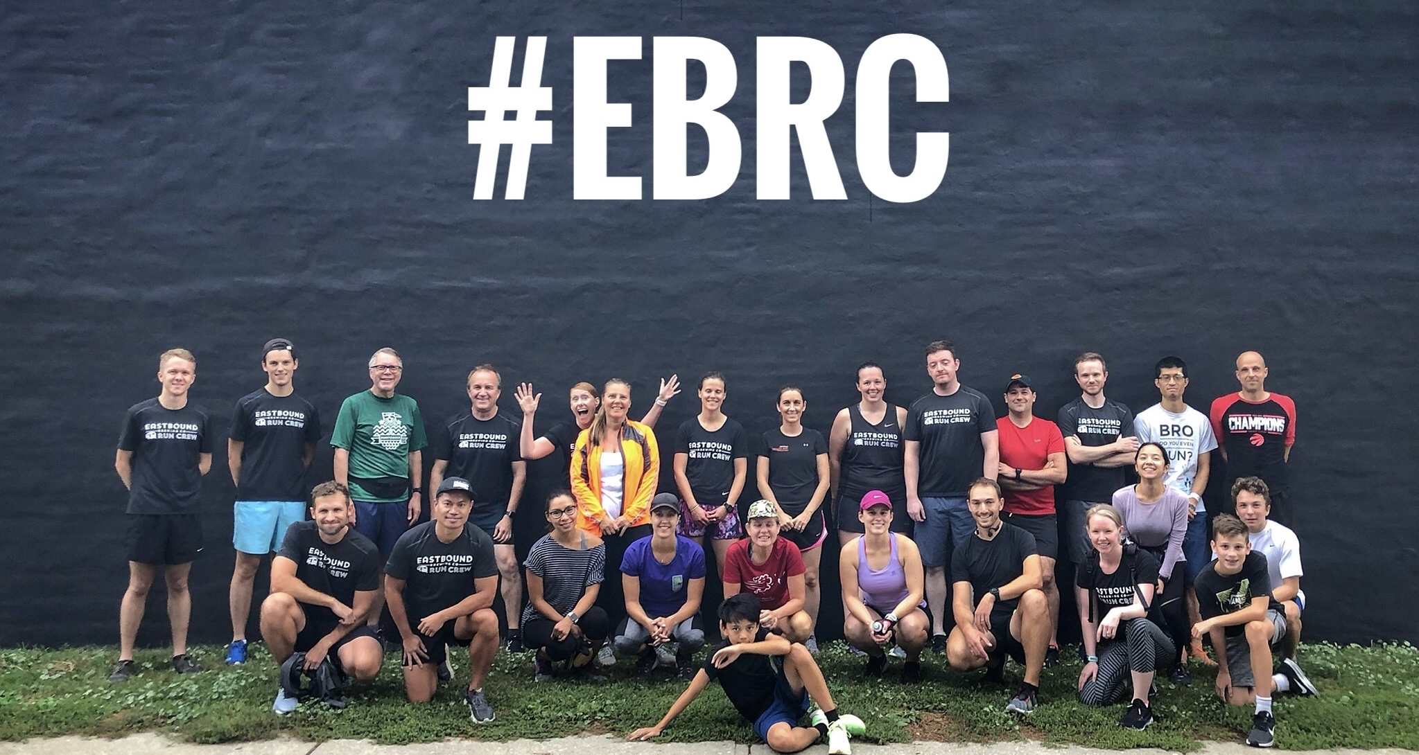Group shot of runners against a black wall with #EBRC super imposed above